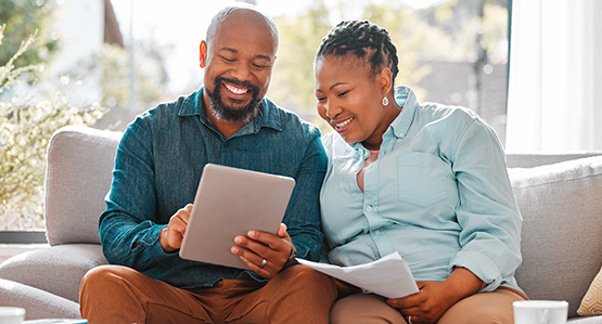 Couple filling out a form on her tablet